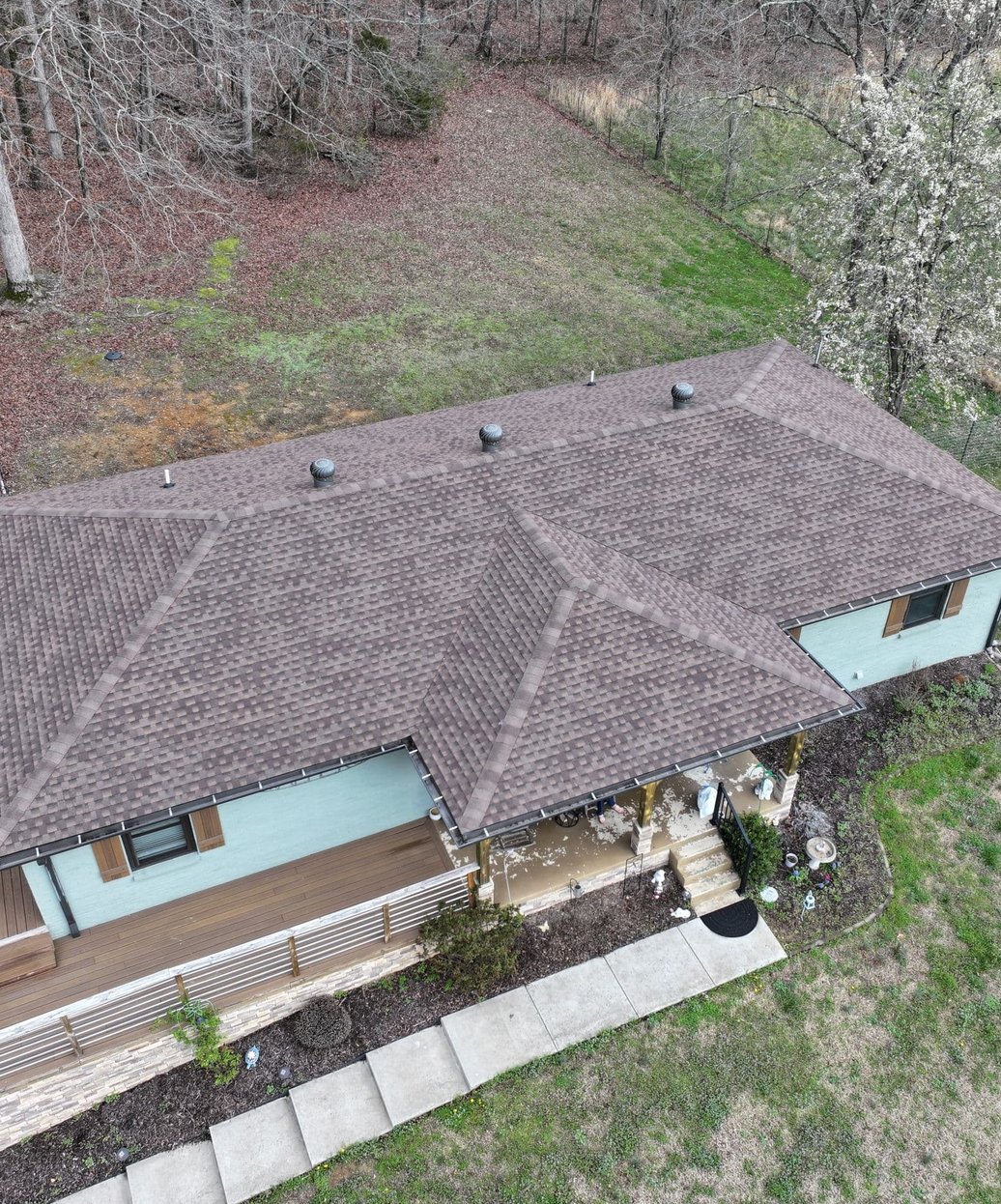 A modern home with a professionally installed dark metal tile roof showcasing clean lines and durable construction.
