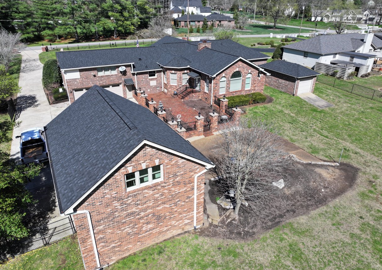 A complex roof design with multiple gables, valleys, and dormers, all covered in high-quality asphalt shingles