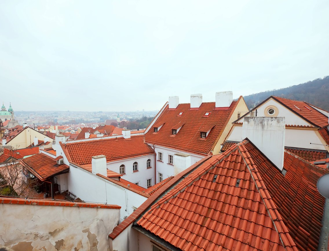 A dense cluster of buildings with red, mission-style roofs.